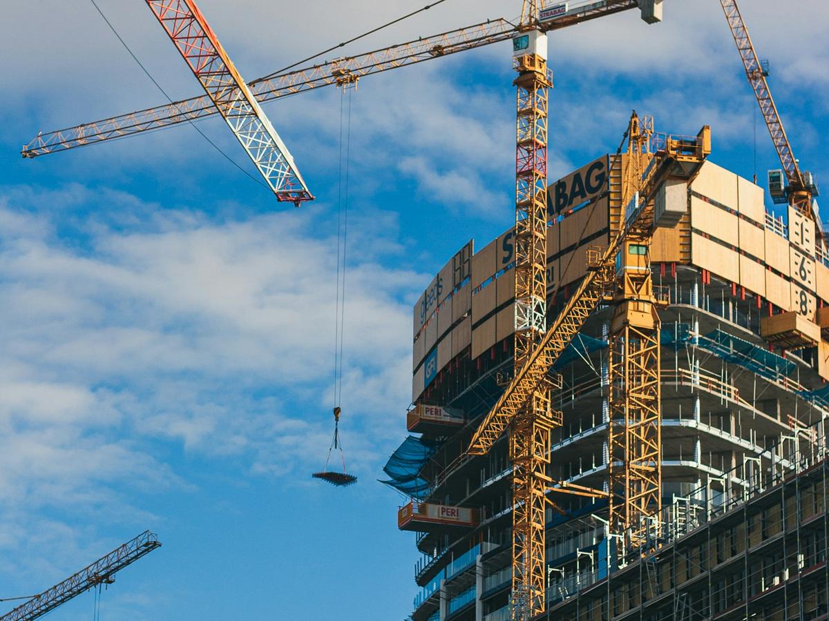 High-rise building under construction with a tower crane